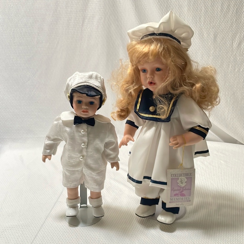 Pair boy & girl bisque porcelain 12” & 15” sailor dolls.